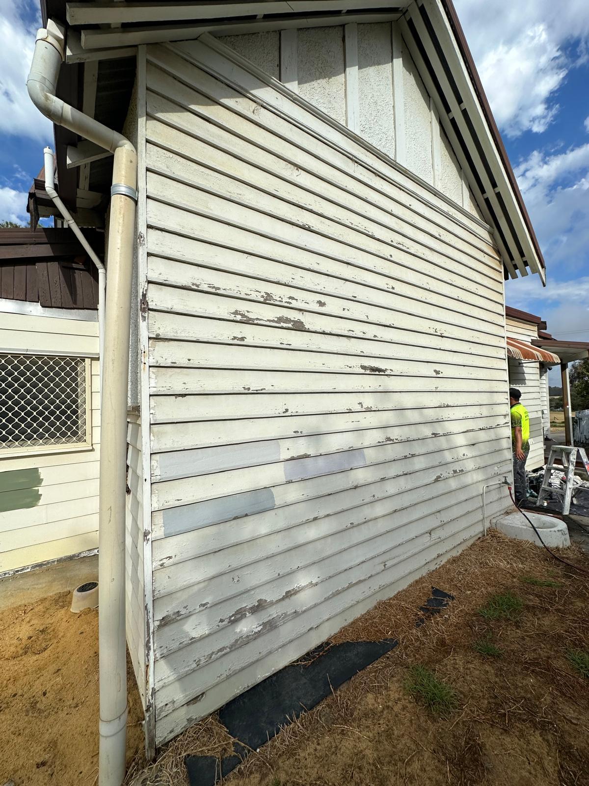 Weatherboard siding before repair — peeling paint and surface damage, Perth